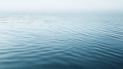 Naklejka premium Soft ripples create a serene atmosphere on the calm water surface in early morning light