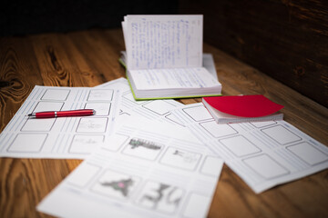 Creative workspace with notes and sketches scattered on a wooden desk, inspiring ideas and plans for projects