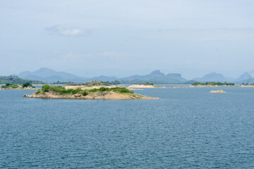 View across small islands in reservoir known as Gal Oya Lake and blue water to surrounding mountains of Gal Oya Sri Lanka