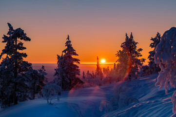 Lapland in winter with large amount of snow during colourful sunset