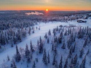 Aerial view of beautiful winter landscape in Lapland during sunset.