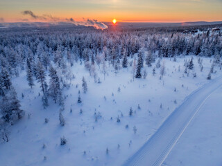 Aerial view of beautiful winter landscape in Lapland during sunset.