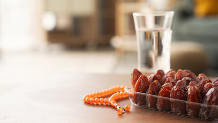 Dried sweet dates in bowl close up, on table