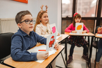Group of elementary students learning together at language school