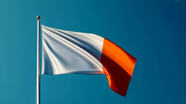 Vibrant flag waving against a clear blue sky, symbolizing national pride and identity