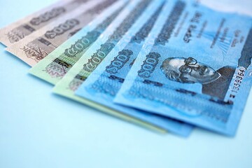 Bangladeshi taka money bills in big amount lies on teal color table close up
