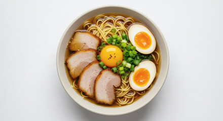 Fototapeta premium bowl of ramen with sliced pork, egg, and green onions, photographed from above on a white background.