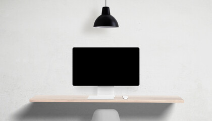 Desktop computer with blank screen on clean desk, overhead lamp and empty side space, perfect for...