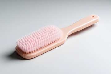 Pink hairbrush on a light background