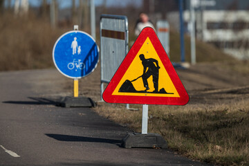 Construction work warning road sign.