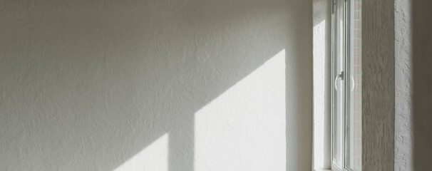 Sunlight falls through the window opening