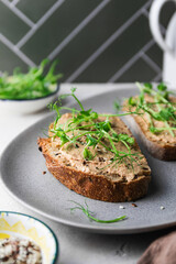 Rye toasts with a turkey pate and microgreens, healthy breakfast