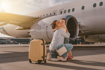 A touching loving moment shared between a caring mother and her child taking place at an airport...