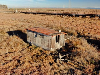 Dilapidated wooden shack sits in a marshy field near a railway in Black Point, Novato, California,...