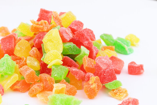 Assorted colorful dried fruit candy pieces on white background