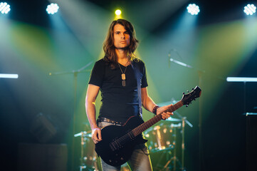 Guitarist performing live on stage with electric guitar