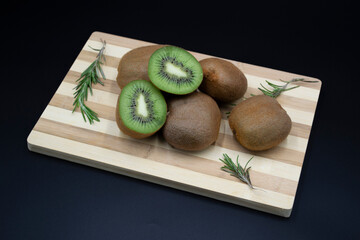 kiwi fruit on a wooden plate