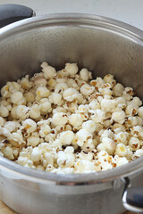 Popcorn in a cooking pot. Close-up. Selective focus. Healthy homemade salty snack food.
