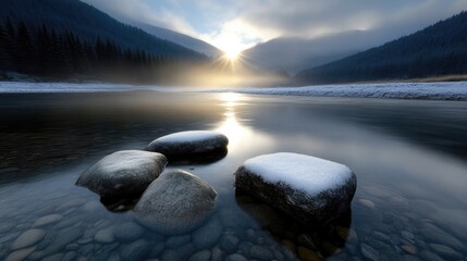 Winter sunbeams on a tranquil river.  Snowy rocks sit in shallow, clear water.  Misty mountains rise in the background