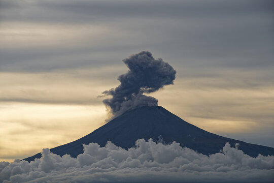 Popocat&eacute;petl volcano eruption smoke at the daytime with beautiful white clouds and blue sky, Mexico