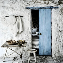 Rustic Mediterranean cottage bedroom glimpse, breakfast table, whitewashed walls,  peaceful background.  Home decor inspiration