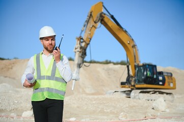 Extraction of stone. Male worker next to stone quarry. Engineer at construction site
