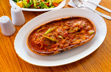 Spicy meatballs with vegetables and garlic in tomato sauce, popular dish of turkish and greek cuisine