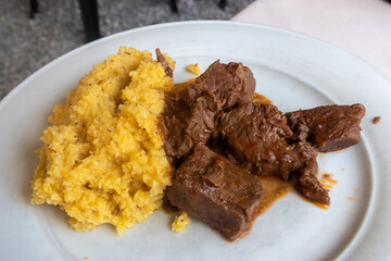Typical dish of Bergamo - braised beef in red wine with polenta