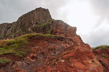 A rocky hillside with a large rock in the foreground