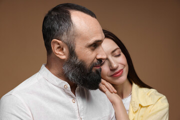 Fototapeta premium Happy daughter and father on brown background