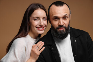 Portrait of happy daughter and father on brown background