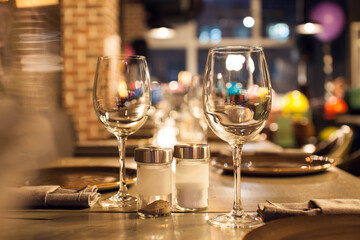 Elegant restaurant table setting with wine glasses and warm ambient lighting