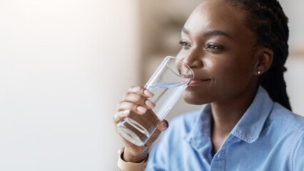 Hydration. Beautiful African American Woman Drinking Mineral Water From Glass And Looking Away,...