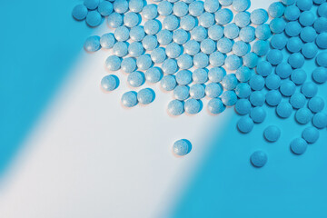 Close up of medical pills on white background with blue shadows