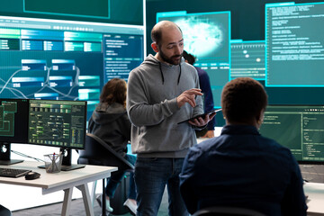 Cyber security team conducting cyber surveillance in a governmental control room. Experts group...