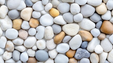 Close-up view of various small, smooth stones in pastel colors