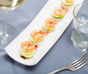 Delicious seafood dish, grilled shrimps served on rice with lime and saffron