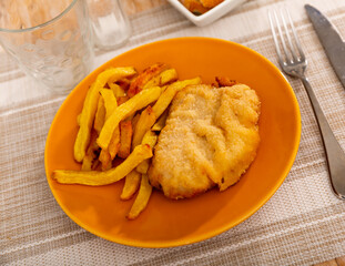Traditional Spanish dish is goat cheese and pepper booklets served with appetizing French fries
