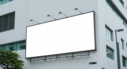 Fototapeta premium A large blank billboard is mounted on a modern building on a busy street. Its empty surface invites advertisers to promote their brands, products, or events for passersby to see