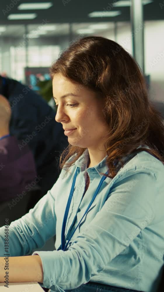 Poster vertical video employee at office desk typing on keyboard, editing documents on computer. worker inp