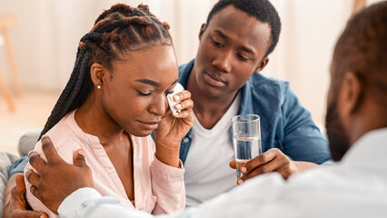 Counselor Comforting Crying Black Woman Sitting With Husband At Family Therapy Session. Selective Focus, Closeup