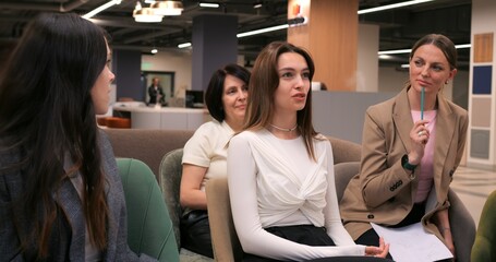 Job applicant gesturing while communicating with recruiters during interview, highlighting professional nonverbal interaction in modern corporate environment. concept of woman is collection
