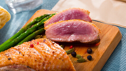 Duck breast with baked onions and asparagus. High quality photo