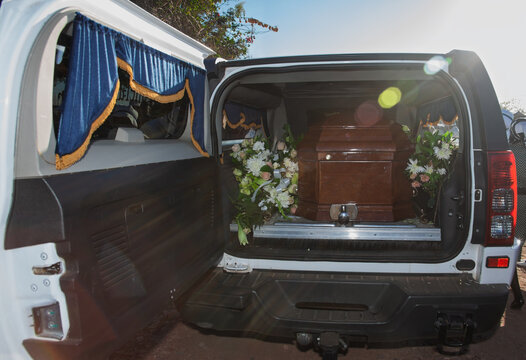 Fototapeta hearse funeral truck with the coffin and dead body inside, Mortuary van surrounded by flowers, funeral services transport