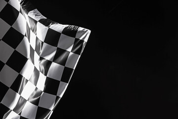 One racing checkered flag on black background, space for text