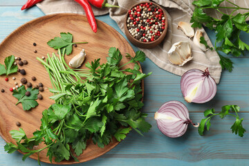 Fresh parsley and spices on blue wooden table, flat lay
