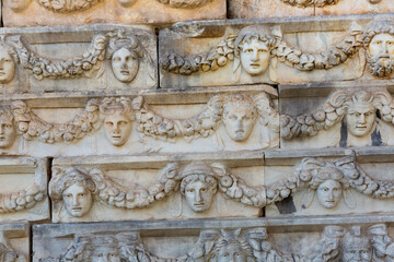 Ancient bas-reliefs in the form of masks in Aphrodisias, Turkey..