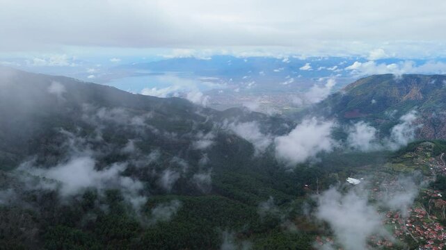 road in the forest and cloudy sky from the mountains, view of mugla koycegiz lake from a distance