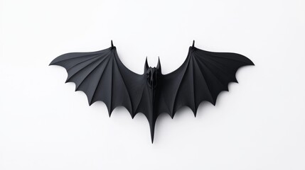 Black bat figurine on white background.  Detailed black plastic bat with outstretched wings,  perfect for Halloween decorations or display