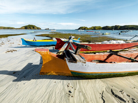 Traditional boats lined on the shoreline at low tide, Tanjung Aan, Lombok, Indonesia